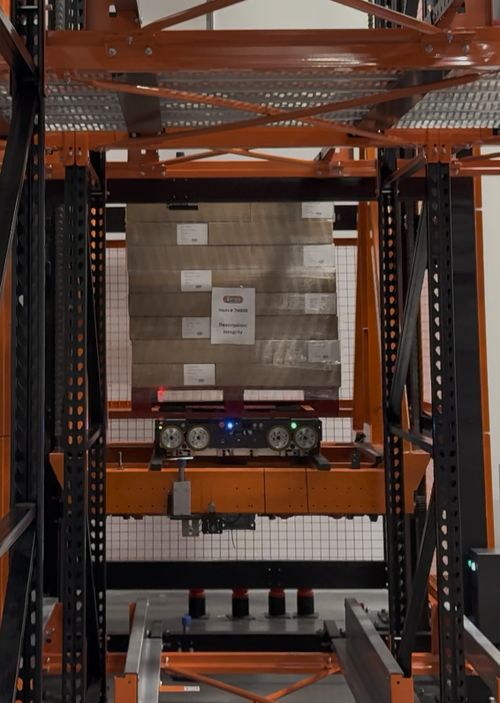 Vertical Transfer Unit (VTU) — PES-wrapped device carrying a pallet between levels in a live deployment