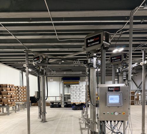 RoboScan portal scanners in a live Prime deployment — MobilePallet AMRs drive pallets through the scanner, PES records the audit trail automatically