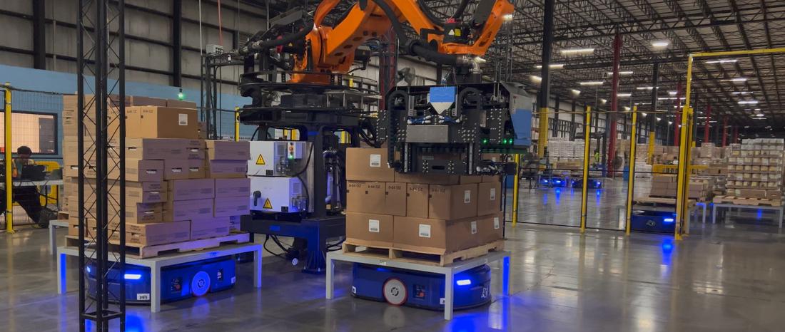 Robotic arm case-picking with Prime MobilePallet AMRs staging pallets — PES-orchestrated live deployment
