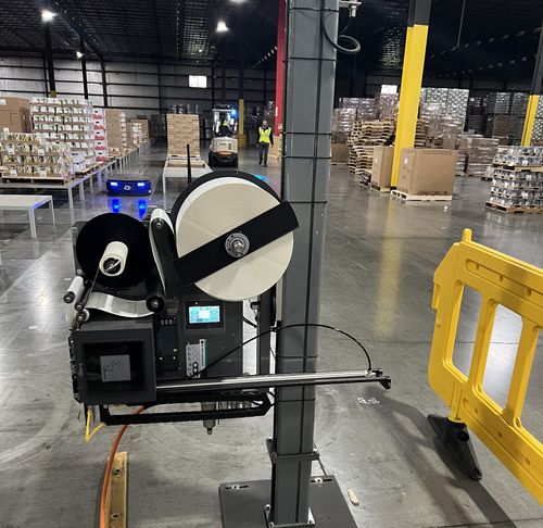 Print-and-Apply (PANDA) labeling machine in a live Prime deployment — integrated as a PES workflow device
